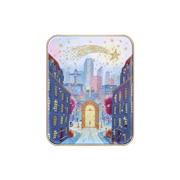 Photo of the 26 AW Holiday Collection limited-edition EYE COLOR QUAD case. The closed rectangular compact lid features a detailed scenic illustration of a city street leading to a large gold gate under a starry sky with a large gold shooting star across the top.