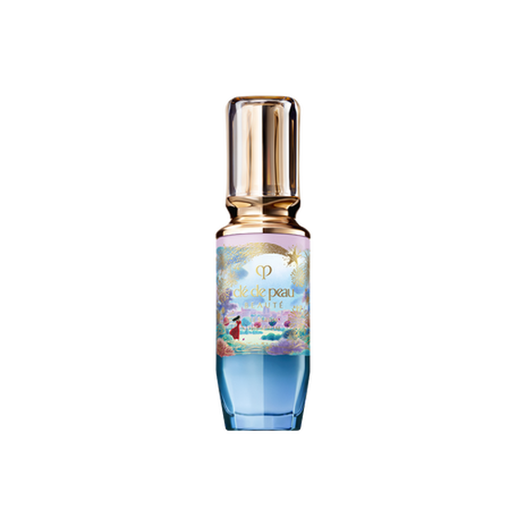 Photo of the 26 AW Holiday Collection limited-edition THE SERUM. The glass bottle features a blue and pink pastel gradient decorated with a gold shooting star and scenery illustration, topped with a clear gold cap.