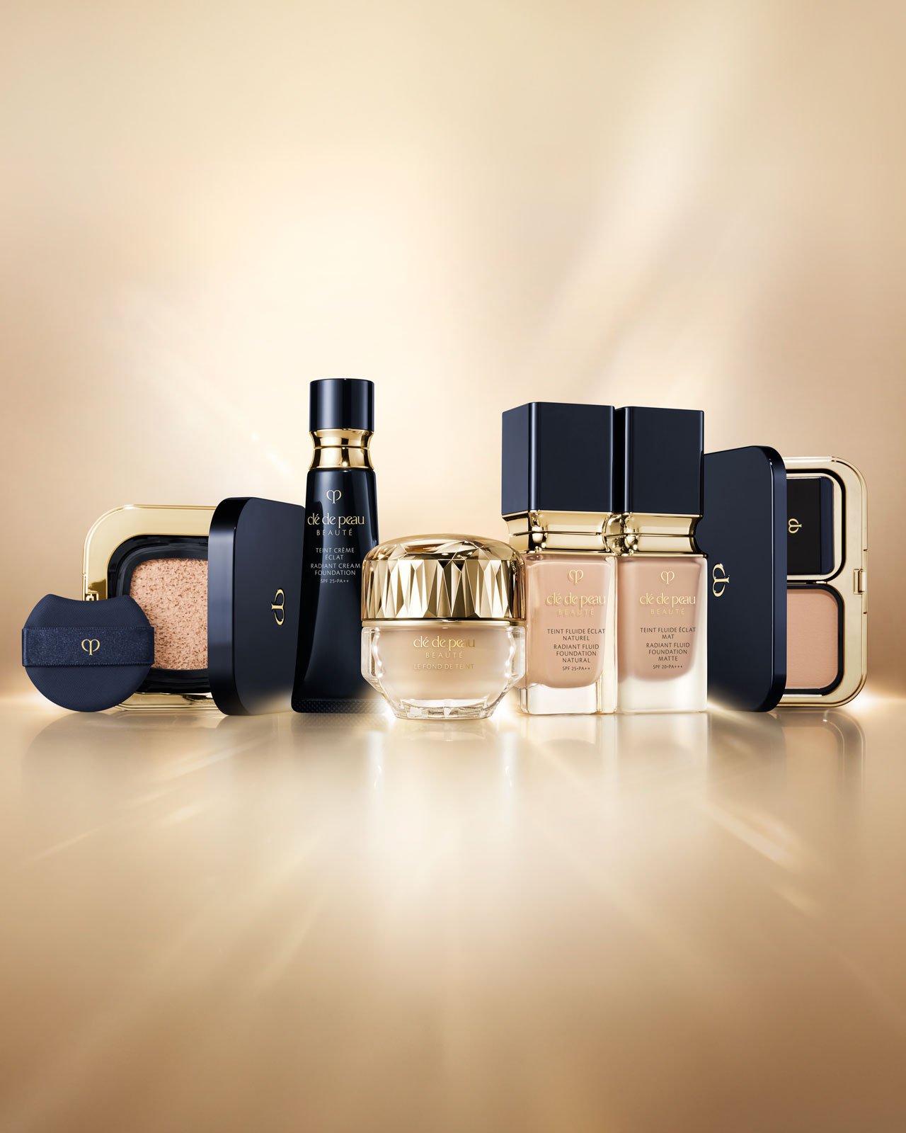 Photo of The Foundation placed at the center, with the Radiant foundation lineup arranged on both sides, all set against a glowing golden background.